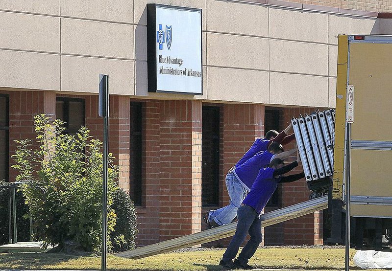 Arkansas Democrat-Gazette/BENJAMIN KRAIN --11/18/2014--
Movers load office equipment into a truck from the soon-to-be-vacated Blue Advantage Administrators of Arkansas building adjacent to the Clinton National Airport. The Little Rock Municipal Airport Commission voted to enlist a local commercial real-estate firm to market available buildings on or near airport property, including this buidling that began life 20 years ago as a Southwest Airlines reservation center. 