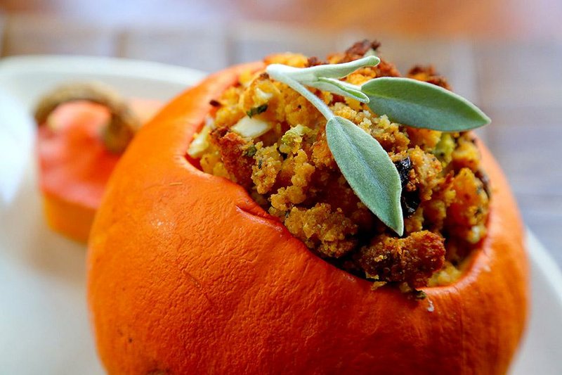Sweet-Savory Cornbread Dressing cooked in a pumpkin makes a festive presentation.