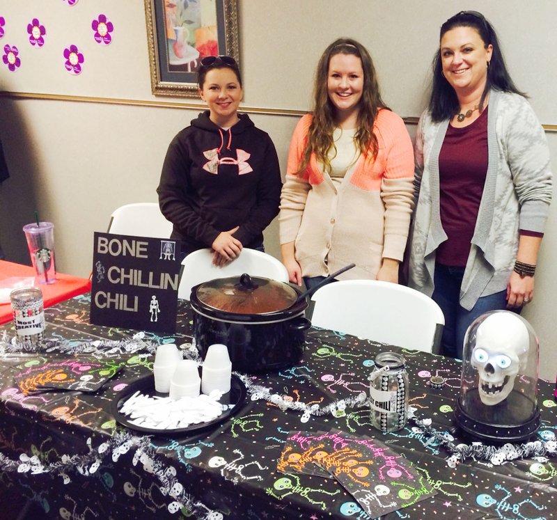 Photo by Amanda Gittlein Kelsey Yarwood, Angela Abercrombie and Ronda Kreutzer, employees in the radiology department at Ozarks Community Hospital, submitted one of the seven entries in the chili cook off at the Nov. 8 fall festival. Their &#8220;Bone Chillin&#8217; Chili&#8221; entry fit right in with their line of work.