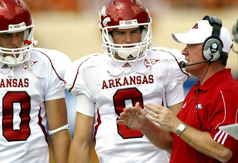 Former Arkansas quarterback Tyler Wilson (center) said Wednesday that is was difficult playing quarterback for Bobby Petrino, but he said ultimately he benefited from it.