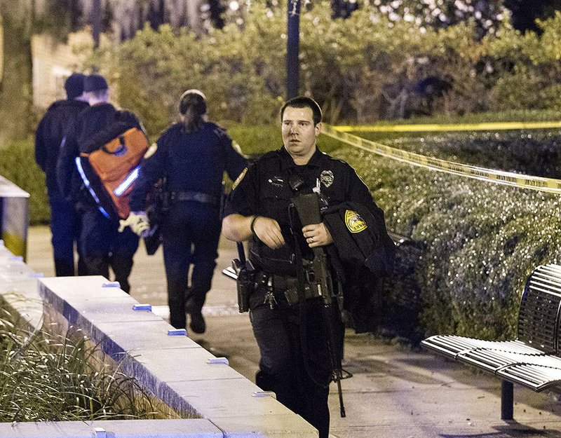 Tallahassee police investigate a shooting outside the Strozier library on the Florida State University campus in Tallahassee, Fla. Thursday Nov 20, 2014.   The gunman was shot and killed by police officers according to Tallahassee Police spokesman Dave Northway. (AP Photo/Mark Wallheiser)