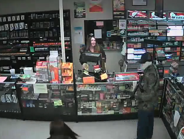 This screenshot from surveillance video released by Russellville police shows a gunman robbing a tobacco store on Nov. 14.