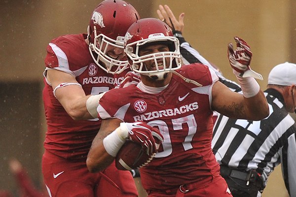 Arkansas defensive end Tevin Beanum reacts after recovering a fumble during the first quarter of a game against Ole Miss on Saturday, Nov. 22, 2014 at Razorback Stadium in Fayetteville. 