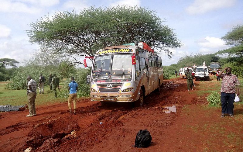 Kenyan security forces and others gather around the scene on an attack on a bus about 50 kilometers (31 miles) outside the town of Mandera, near the Somali border in northeastern Kenya, Saturday, Nov. 22, 2014. Somalia's Islamic extremist rebels, al-Shabab, attacked the bus in northern Kenya at dawn on Saturday, singling out and killing 28 passengers who could not recite an Islamic creed and were assumed to be non-Muslims, Kenyan police said. (AP Photo)