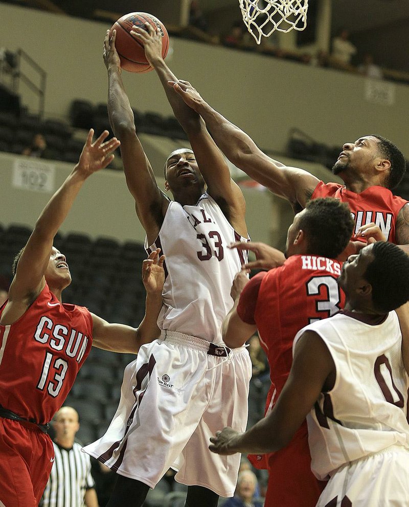  Arkansas Democrat-Gazette/STATON BREIDENTHAL --11/23/14-- UALR forward James White (#33) fights for a rebound with Cal State-Northridge defenders Ajon Efferson (#13), Stephan Hicks (#3) and Aaron Parks along with teammate Roger Woods (#0) Sunday during their game at the Jack Stephens Center in Little Rock.