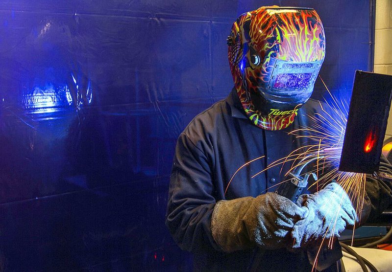Arkansas Democrat-Gazette/BENJAMIN KRAIN --11/13/2014--
A welding student is lit by his torch while working on a project during a class at Pulaski Technical College in North Little Rock. The trade school program gets requestes from buisnesses from all over the mid-south looking for students who are ready to go to work.