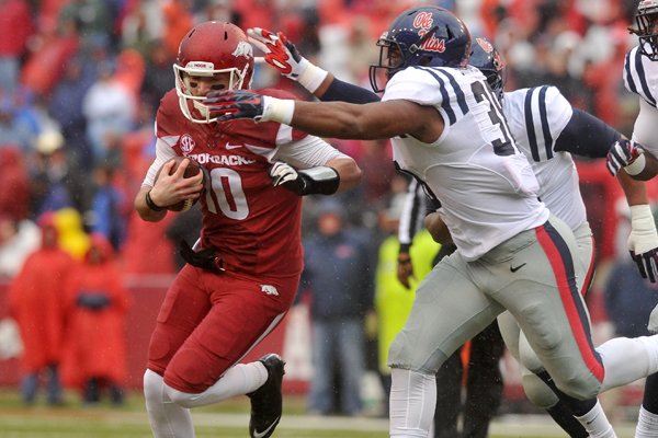 Arkansas quarterback Brandon Allen scrambles out of the pocket as he runs for a gain in the first quarter of Arkansas' 30-0 win over No. 8 Ole Miss on Nov. 22, 2014, at Razorback Stadium.