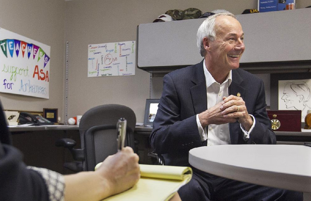 File Photo -- Asa Hutchinson meets with staff members Wednesday at his campaign headquarters in Little Rock as the Republican governor-elect began working on his transition with a series of meetings.