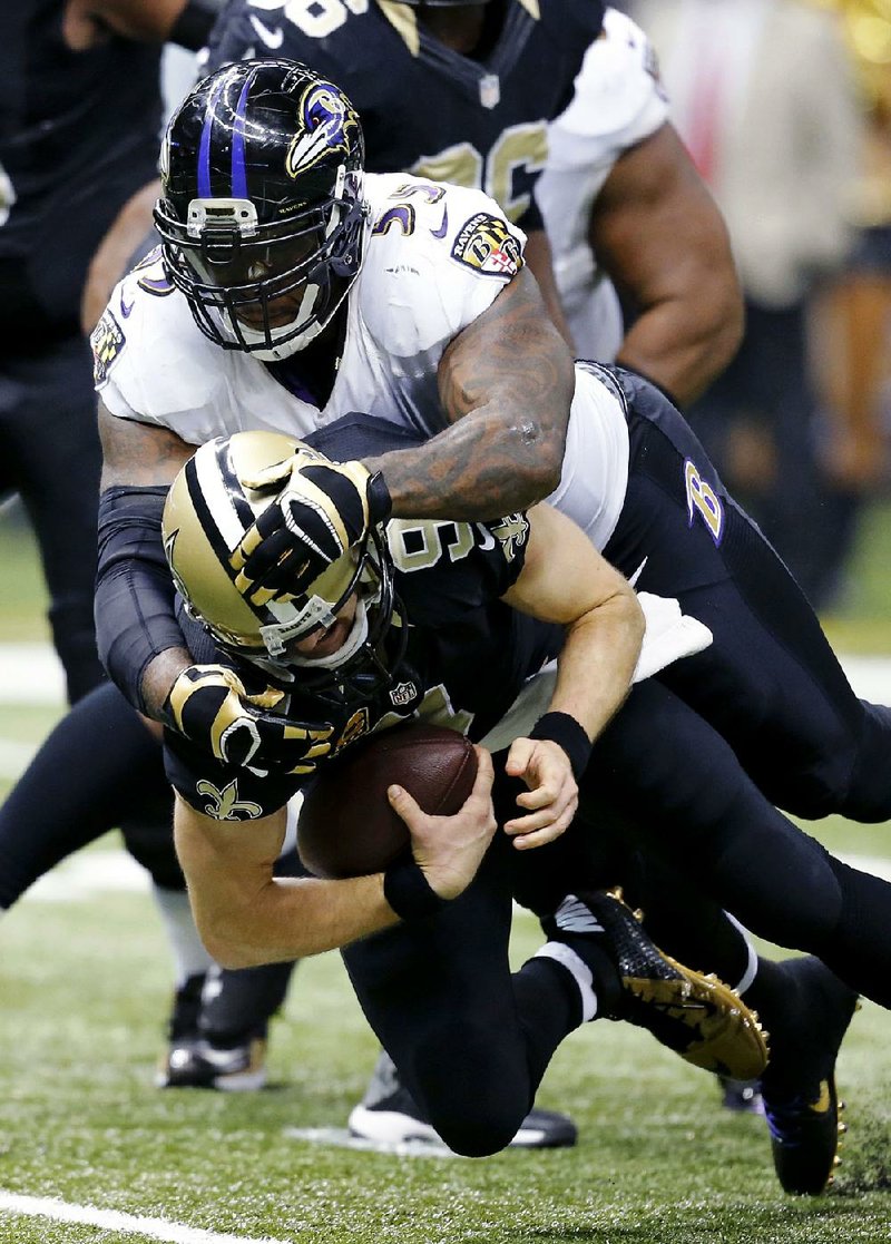 New Orleans Saints quarterback Drew Brees (9) is tackled by Baltimore Ravens outside linebacker Terrell Suggs (55) in the first half of an NFL football game in New Orleans, Monday, Nov. 24, 2014. (AP Photo/Rogelio Solis)