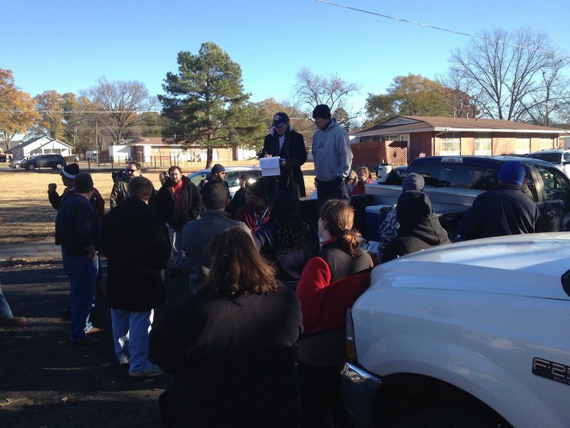 Volunteers gather Monday, Nov. 24, 2014, at West Park and South Maple avenues in Searcy in the search for missing 2-year-old Malik Drummond.