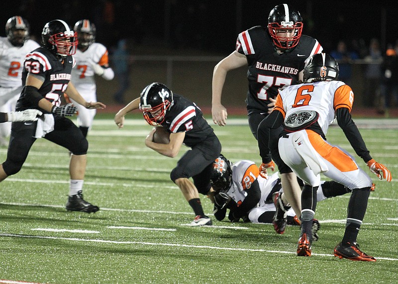 Tail back Shane Ivy was brought down as left tackle Brent Ferguson keeps Malvern defenders at bay.