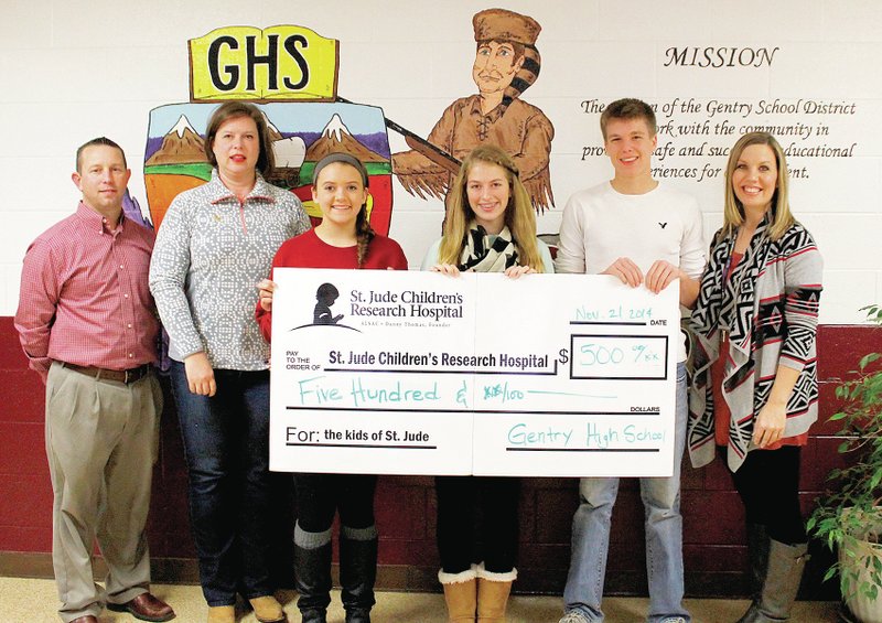 Photo by Patrick Lanford Gentry High School students presented money the high school raised for St. Jude Research Hospital. Presenting the check are Hayley Hays, Lexie Clark, Gavin Martin and Jenifer McMurray, high school teacher who spearheaded the campaign. Also pictured are high school principal Brae Harper and Amy Beth Dudley, representative from St. Jude.