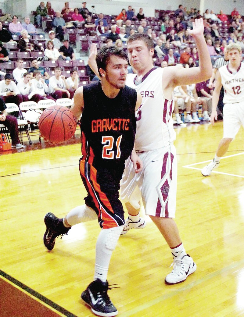 Photo by Randy Moll Gravette guard Dustin Morgan dribbles the ball under the basket in play against Siloam Springs on Thursday. The non-conference contest was to help prepare the Lions for upcoming conference play.
