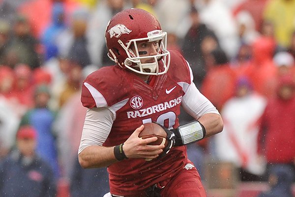 Arkansas quarterback Brandon Allen scrambles during the first half of a game against Ole Miss on Saturday, Nov. 22, 2014 at Razorback Stadium in Fayetteville. 