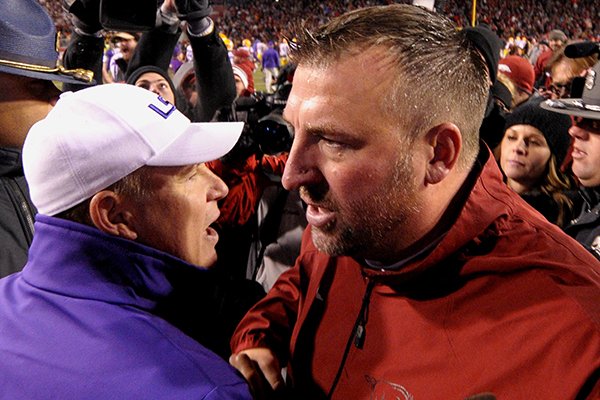 Arkansas coach Bret Bielema, right, shakes hands with LSU coach Les Miles after Arkansas defeated LSU 17-0 in an NCAA college football game in Fayetteville, Ark., Saturday, Nov. 15, 2014. (AP Photo/David Quinn)