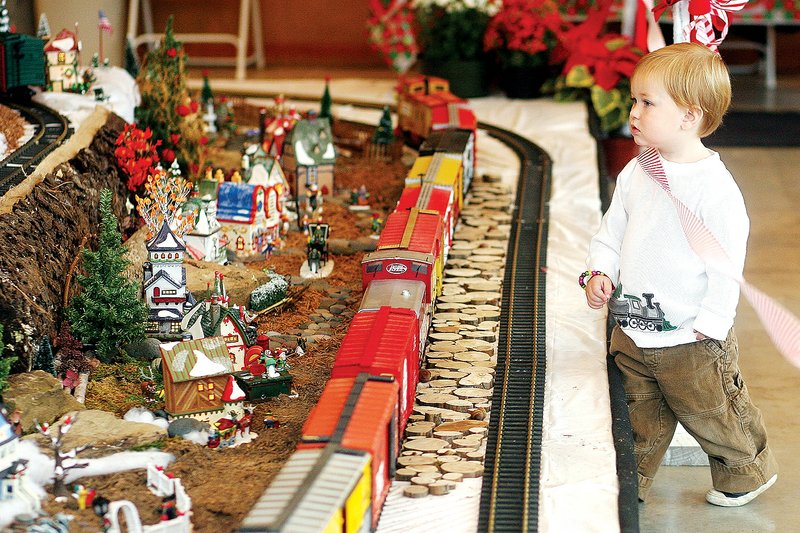 Hayes McKelvain of Springdale looks over the Gardenland Express at the Botanical Gardens of the Ozarks in Fayetteville. This year’s display will continue through Dec. 16.