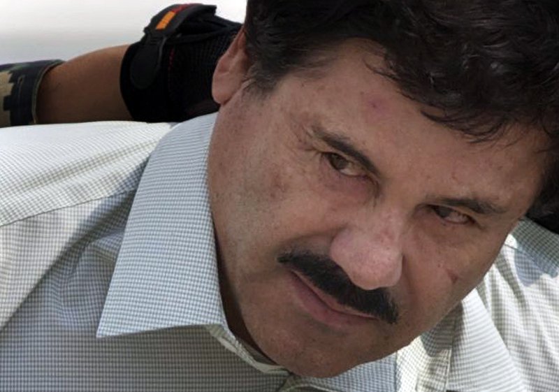 In this Feb. 22, 2014, file photo, Joaquin "El Chapo" Guzman is escorted to a helicopter by Mexican navy marines in Mexico City, Mexico. The normally bucolic, vacationer-laden Mexican state at the tip of Baja peninsula is now the scene of dozens of killings in what authorities call a power struggle resulting from the February arrest of international drug lord Joaquin El Chapo Guzman.