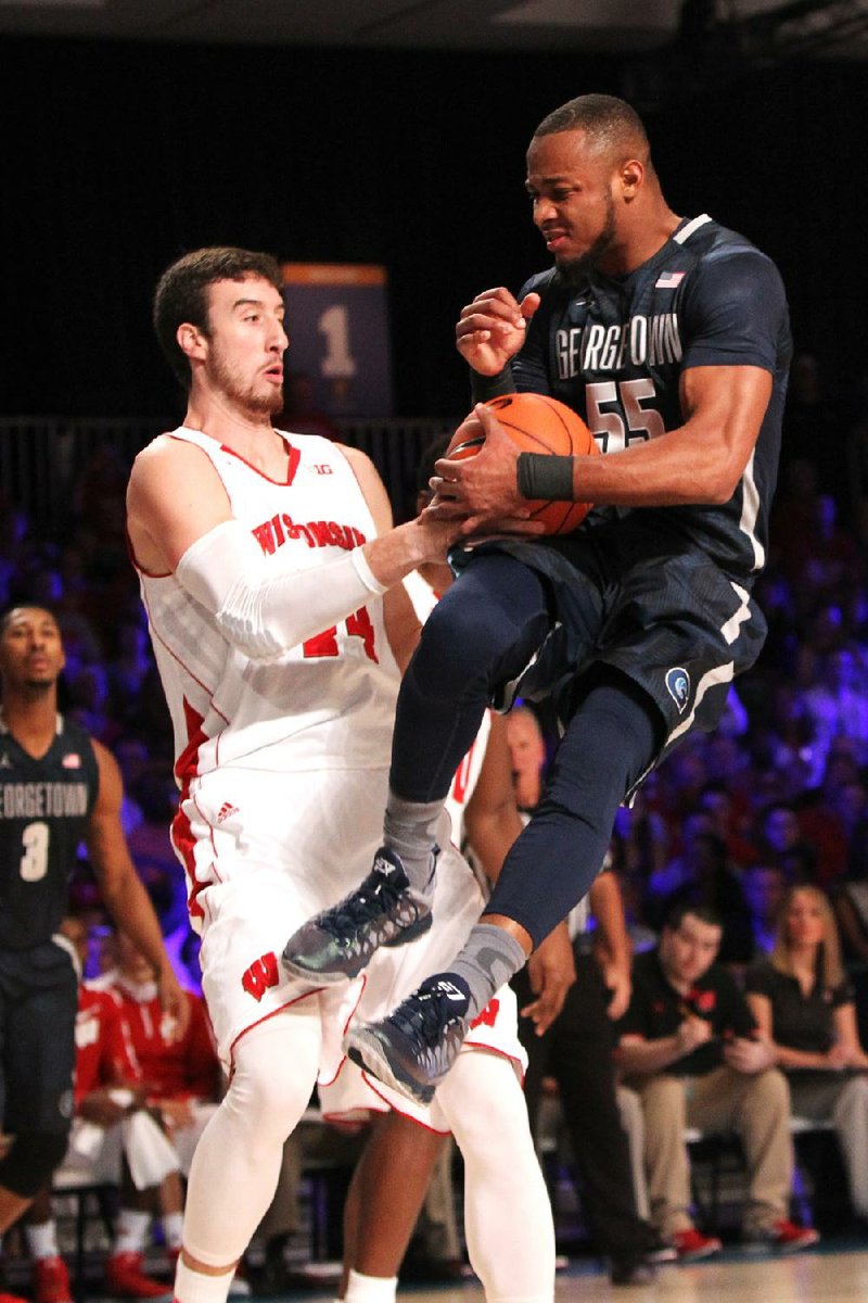 Wisconsin’s Frank Kaminsky (left) and Georgetown’s Jabril Trawick fight for a loose ball during the No. 2 Badgers’ 68-65 victory over the Hoyas on Thursday in the Battle 4 Atlantis at Paradise Island, Bahamas.