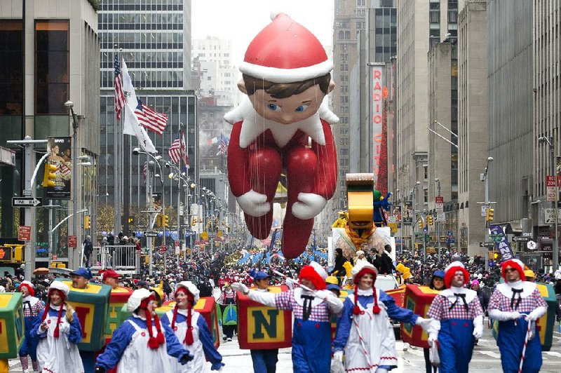 The Elf on the Shelf balloon is marched down Sixth Avenue during the annual Macy’s Thanksgiving Day Parade in New York.