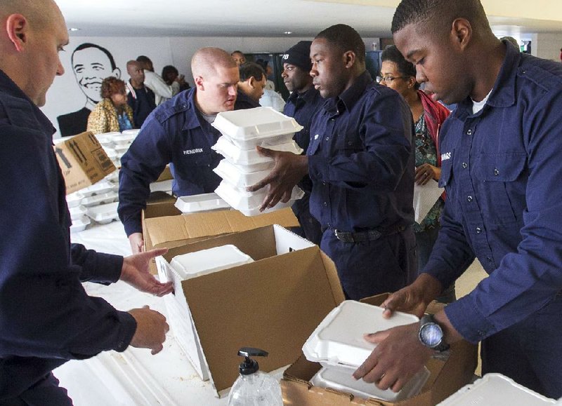 Little Rock Police Department recruit-school cadets help hundreds of other volunteers at the Watershed Family Resource Center cook, package and deliver more than 5,000 free Thanksgiving Day meals for shelters, public housing, senior-citizen homes and other organizations in need.