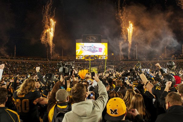 Missouri fans rush the field and celebrate after the team's 21-14 victory over Arkansas in an NCAA college football game Friday, Nov. 28, 2014, in Columbia, Mo. Missouri won 21-14. (AP Photo/L.G. Patterson)