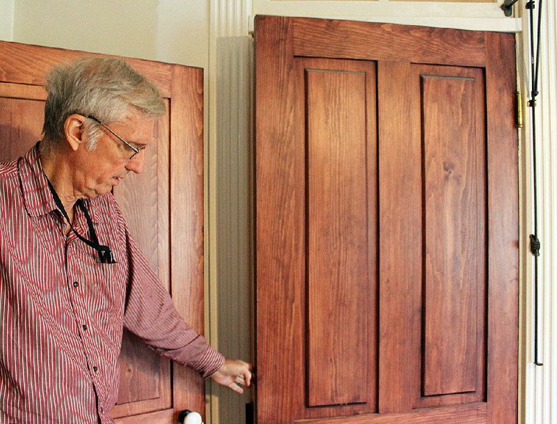 Terry Shipman shows off one of several doors he had custom made for the family home he’s restoring in Newark. The doors are wider and taller than modern doors, and have transoms at the top. Transoms, Shipman said, are the 19th-century version of air conditioning.