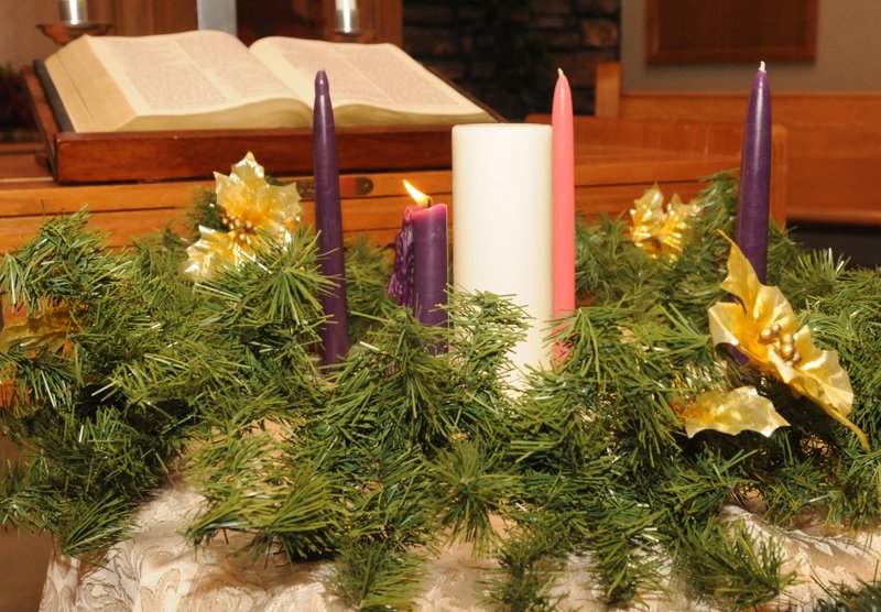 FILE PHOTO An Advent wreath laid in a circle represents eternity. The four outer candles represent love, peace, joy and hope, and the inner candle &#8212; the Christ candle lighted on Christmas Eve &#8212; joins the others increasing the light to refer to Jesus Christ, &#8220;The Light of the World.&#8221;