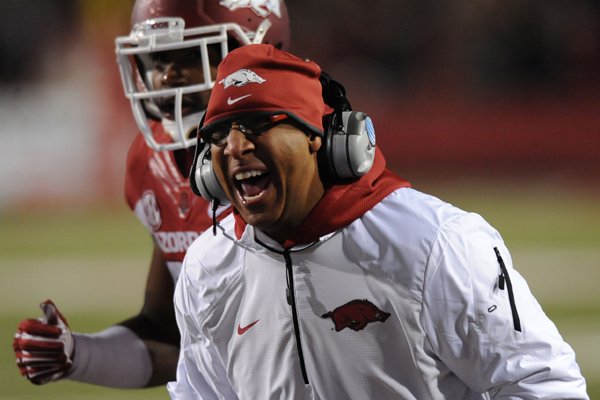 Arkansas assistant coach Michael Smith argues with a game official against LSU during the third quarter Saturday, Nov. 15, 2014, at Razorback Stadium in Fayetteville.