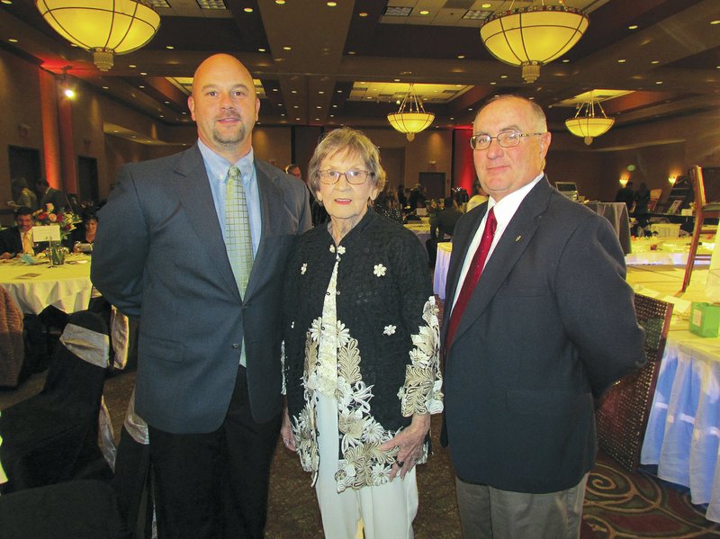 STAFF PHOTO ASHLEY BATCHELOR Denny Upton, from right, gathers with Doris Bishop and her son Dr. Chad Bishop during Starry, Starry Night. Upton and Doris Bishop were two of the honorees at the event.