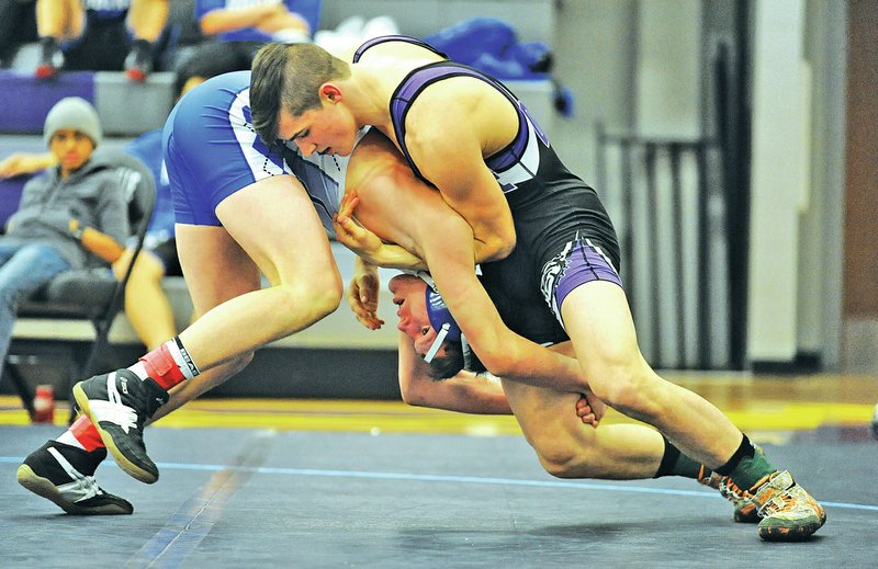 FILE PHOTO ANDY SHUPE Jaxson Nolen, right, Fayetteville senior, wrestles Feb. 1 with Gary Fredrick of Rogers High at Fayetteville High. Nolen is the defending 7A/6A state champion in the 152-pound division and will be a top contender again for the Purple Bulldogs this season.