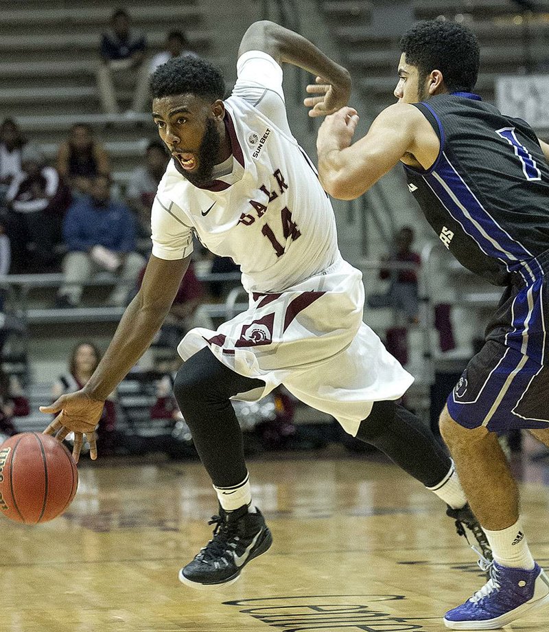 UALR guard J.T. Thomas drives around Central Arkansas defender Jordan Howard during Saturday’s game at Jack Stephens Center in Little Rock. UALR won 85-71 in the first meeting between the schools in 12 years.