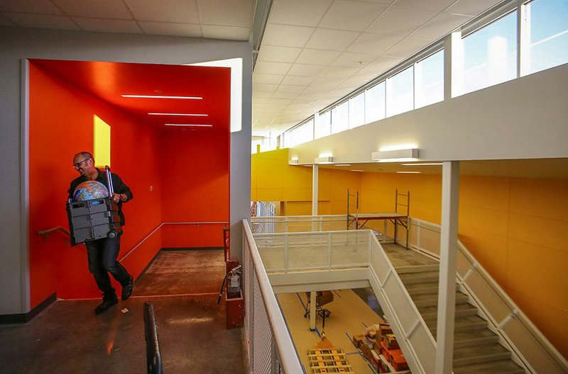 Mark Fonville helps his wife, teacher Kim Fonville, move into her classroom Wednesday at the new Lakewood Elementary School in North Little Rock.