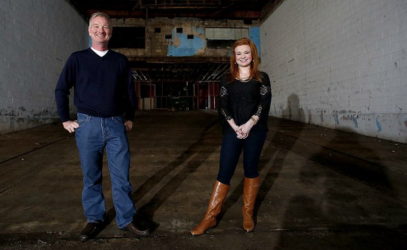 Tom Lundstrum stands Friday with his daughter Gracie Lundstrum in the main part of the Apollo Theater in Springdale. Tom Lundstrum, co-owner of the theater, is hoping to restore it to how it looked in the 1950s. 
