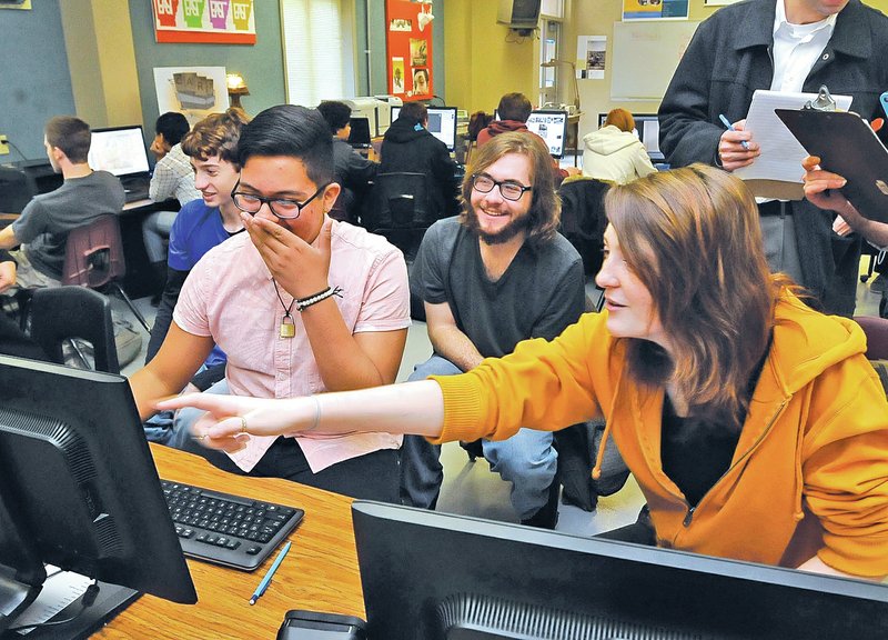  STAFF PHOTO FLIP PUTTHOFF Bentonville students Tristan Hoofman, far left, Adrian Serrano, foreground left, Cody Hiatt and and Eryn Stuebgen, right, work on their EAST project on Nov. 21. EAST is a self-directed class in which students use state-of-the-art technology to solve real-world problems and perform a service to the community.