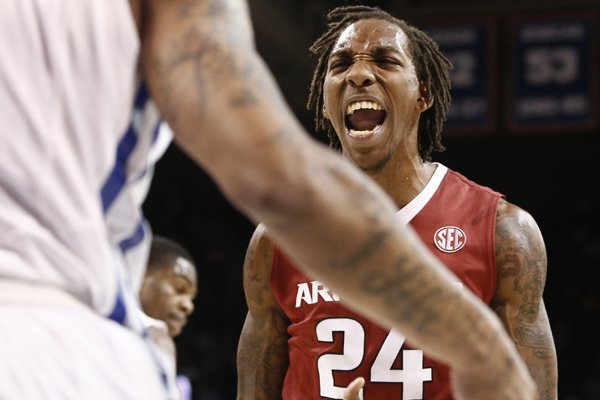 Arkansas Razorbacks guard Michael Qualls (24) reacts in front of Southern Methodist Mustangs guard Keith Frazier (4) after scoring during the first half of an NCAA basketball game, Tuesday, Nov. 25, 2014, in Dallas. (AP Photo/Jim Cowsert)