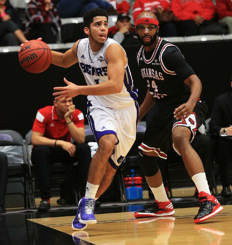 Arkansas Democrat-Gazette/RICK MCFARLAND --12/01/14--  UCA's Jordan Howard gets around ASU's Anthony Livingston (24) at the Farris Center in Conway Monday on Dec. 1, 2014