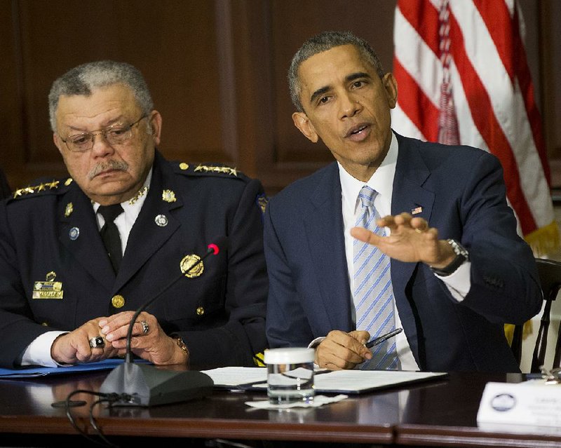President Barack Obama, right, seated with Charles Ramsey, left, Commissioner Philadelphia Police Dept., speaks during his meeting with elected officials, law enforcement officials and community and faith leaders in the Old Executive Office Building on the White House Complex in Washington, Monday, Dec. 1, 2014. Obama said that in the wake of the shooting of an unarmed 18-year-old man in Ferguson, Missouri, he wants to make sure to build better trust between police and the communities they serve.  (AP Photo/Pablo Martinez Monsivais)