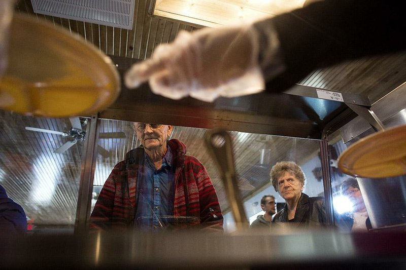 Arkansas Democrat-Gazette/MELISSA SUE GERRITS - 11/17/2014 - Ted Harris, left, and Charlene Redding, right, order lunch at What's For Dinner during their grand reopening after tornado damage in Vilonia, Arkansas November 17, 2014. Harris was born and raised in Vilonia and worked to support the rebuild efforts after the tornado that damaged many homes and business in his hometown. The diner's grand reopening kept a full staff busy and included a visit from Governor Mike Beebe. 