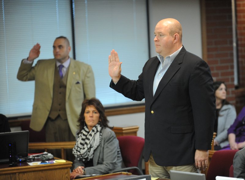 Josh Melton of Fayetteville, right, is sworn in during the first day of his trial Monday, Dec. 1, 2014, at the Washington County Courthouse in Fayetteville.