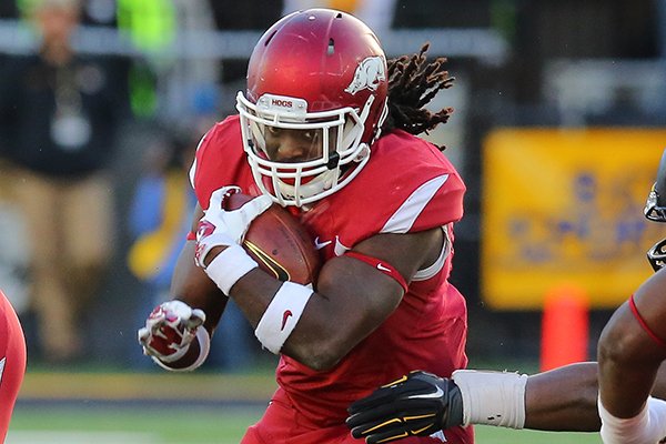 Arkansas running back Alex Collins carries the ball during a game against Missouri on Friday, Nov. 28, 2014 at Faurot Field in Columbia, Mo. 