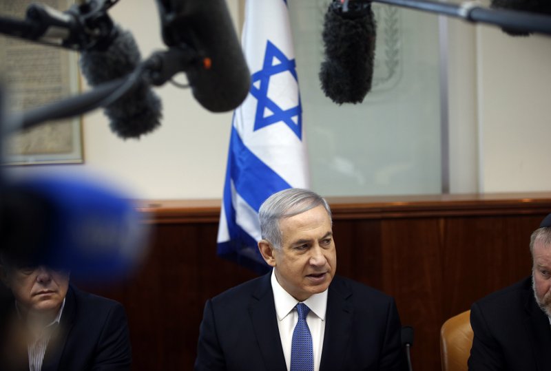 Israel's Prime Minister Benjamin Netanyahu, center, leads the weekly cabinet meeting in Jerusalem on Sunday, Nov. 30 2014. Netanyahu's office announced Tuesday, Dec. 2, 2014, that the prime minister ordered the dismissals of Finance Minister Yair Lapid and Justice Minister Tzipi Livni.
