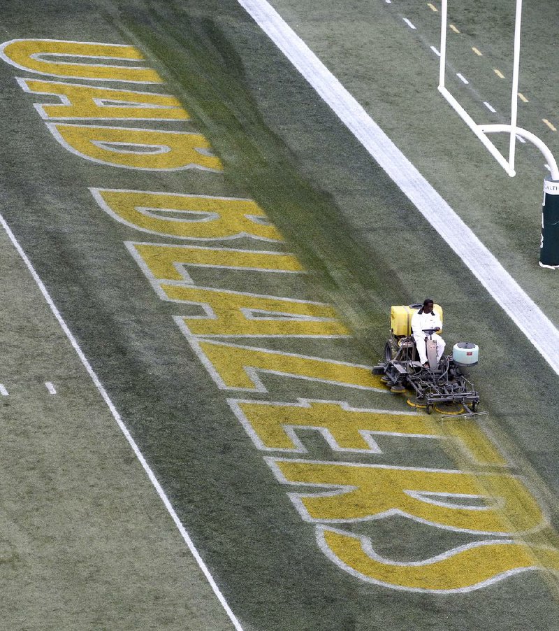 A worker erases the “UAB Blazers” logo from the end zone after Alabama-Birmingham’s final home game of the season Nov. 22 at Legion Field in Birmingham, Ala. The school announced Tuesday that it was eliminating football.