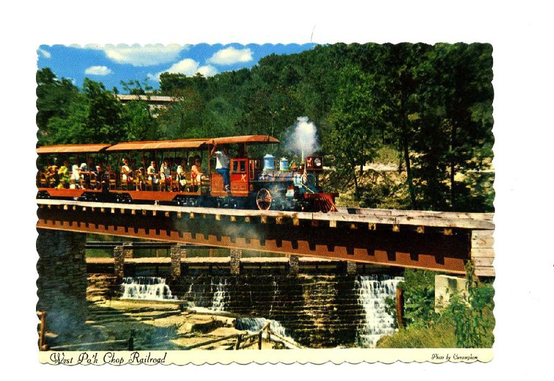 Dogpatch USA in shown in this 1969 postcard. These tourists were enjoying a ride on the West Pork Chop Railway. Dogpatch USA, which opened in 1968, was an amusement park based on characters and locations in Al Capp’s popular “Li’l Abner” comic strip. 