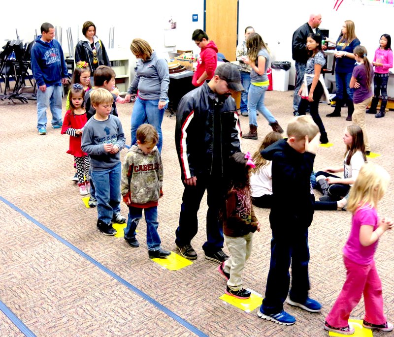 Photo by Mike Eckels Students, some with parental assistance, played a form of musical squares during the Nov. 14 Fall Festival at Northside Elementary. Students had to walk along the squares to music. As soon as the music stopped, the square they landed on earned them a prize.