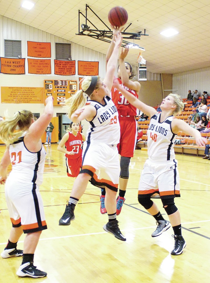 Photo by Randy Moll Gravette&#8217;s Chasity Hubbard and Stephanie Pinter attempt to block a Farmington shot by Anna Dutton during play on Nov. 25 at the Lions&#8217; Fieldhouse in Gravette. Jaye Chalk is at the ready in the foreground.