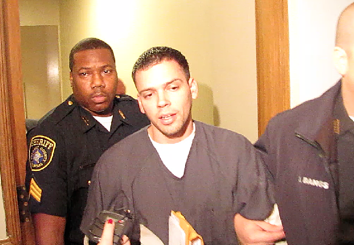 Arron Lewis is escorted from Pulaski County Circuit Court after an appearance Wednesday.