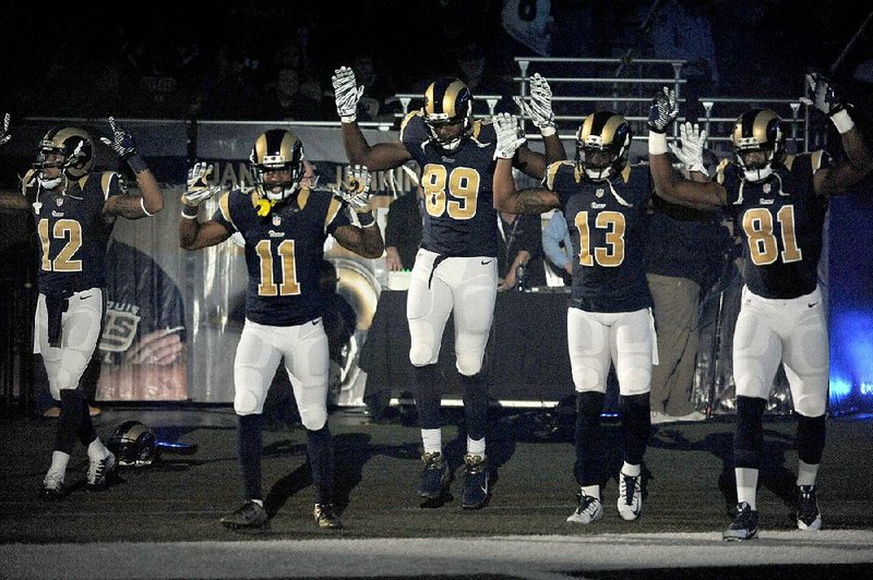 At least St. Louis Rams players adhered to the NFL’s uniform policy while making their “hands up, don’t shoot” gesture before Sunday’s game against the Oakland Raiders.