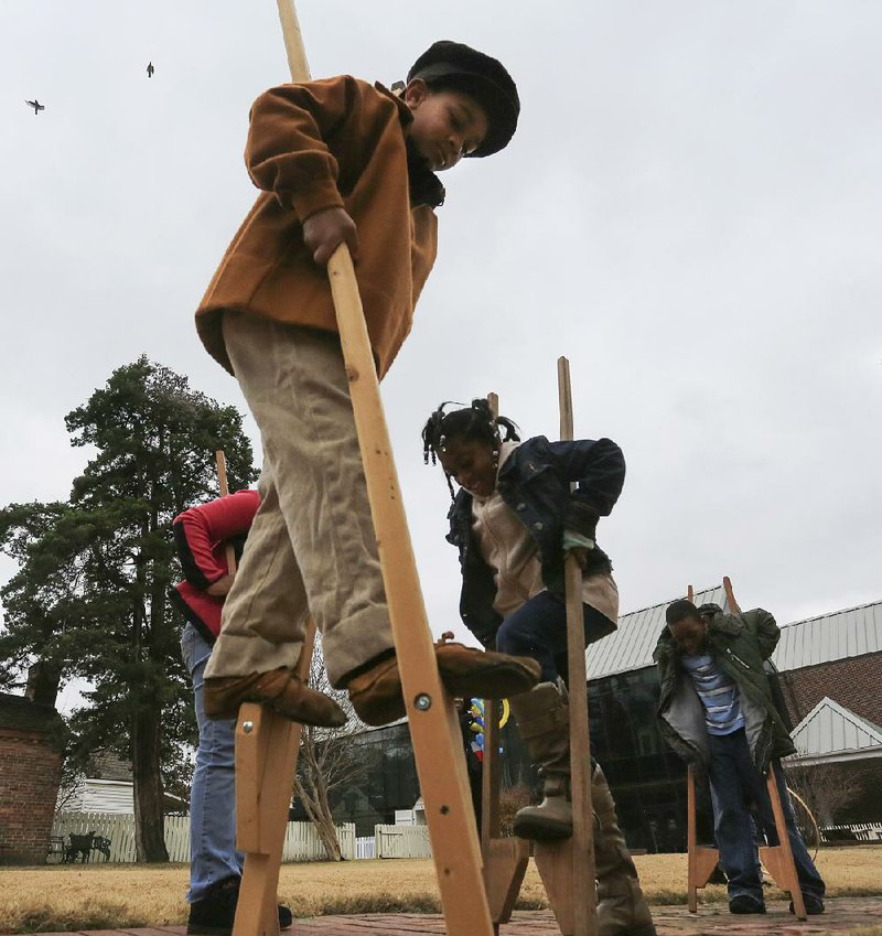 Visiting children can test their stilt skills at the Historic Arkansas Museum’s Christmas Frolic on Sunday.