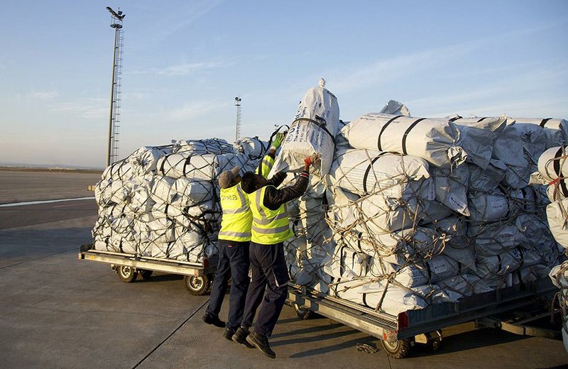 Workers load pallets with winter supplies, which arrived by air Thursday in Irbil, northern Iraq, from the United Nations refugee agency. The United States delivered 25,000 winterization kits for displaced people fleeing Islamic State militants. 