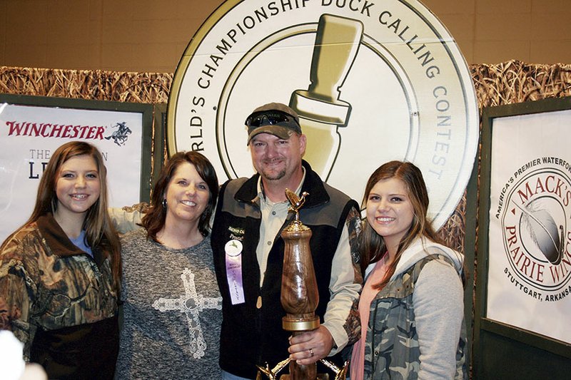 David St. John of Conway poses with his family, from left, daughter Allie, wife Michele and daughter Kaylee, after he won the 2014 World’s Championship Duck Calling Contest on Nov. 22 in Stuttgart. St. John, a graduate of the University of Central Arkansas, works for Echo Calls in Beebe, and Michele teaches at Marguerite Vann Elementary School in Conway.